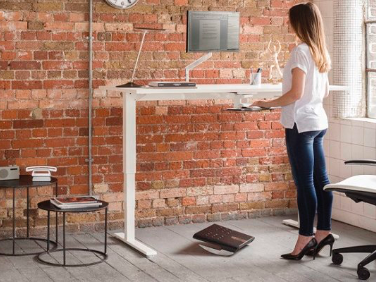 white height adjustable desk in private office